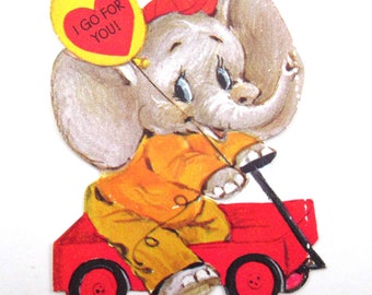 Carte de Saint-Valentin pour enfants vintage avec un joli éléphant de cirque dans un wagon ou un ballon rouge par Ambassador