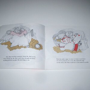 May include: An open book with illustrations of bears in a cozy setting. One image shows a bear in bed with an alarm clock. The other shows a bear with a sign that reads, "IT'S NICE TO SHARE VALENTINE'S DAY WITH SOMEONE YOU LOVE."
