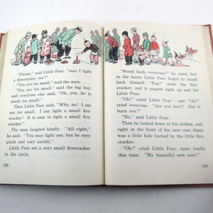 May include: A vintage book open to two pages with illustrations. The images show a group of people, including children, and a child lighting a firecracker. Text accompanies the illustrations.