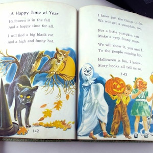 May include: Open book illustration with text about Halloween. The left page shows a black cat, owl, and witch's hat. The right page depicts children in costumes with a pumpkin. Text includes "A Happy Time of Year."