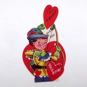 May include: Vintage Valentine's Day card featuring a cartoon archer with a bow and arrow. The archer is dressed in yellow and blue attire, holding a red heart with the words "I'm all a-quiver" and "Valentine". The card is made in the USA.