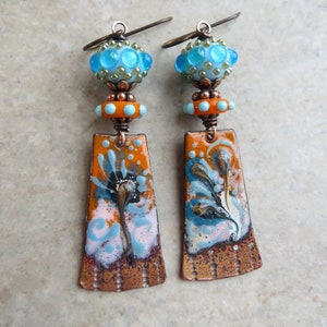 Opposites Attract ... Artisan Handpainted Enameled Copper and Glass Lampwork Earrings. Handcrafted Blue an Orange Floral Boho Earrings.