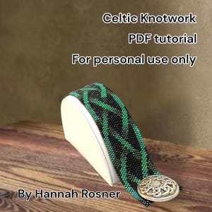 May include: A beaded bracelet with a Celtic knotwork design in black and green, displayed on a white stand. The bracelet has a silver-colored clasp. Text on the image reads "Celtic Knotwork PDF tutorial For personal use only By Hannah Rosner."