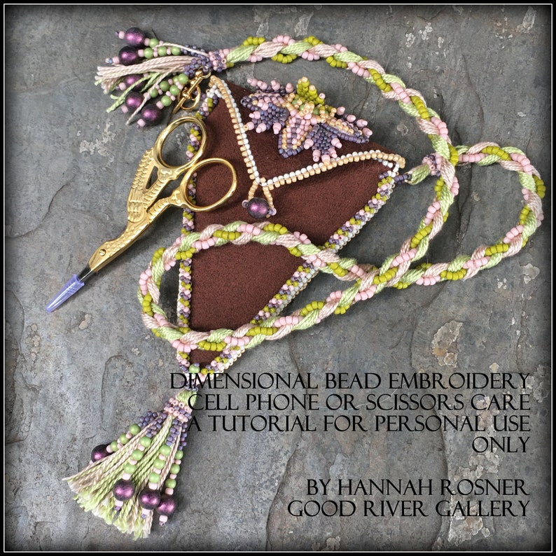 May include: A brown triangular needlepoint pouch with a beaded floral design and a gold scissor charm. The pouch is attached to a long, braided cord with pink, green, and purple beads. The cord has a tassel at the end. The text on the image reads "Dimensional Bead Embroidery Cell Phone or Scissors Care A Tutorial for Personal Use Only By Hannah Rosner Good River Gallery".
