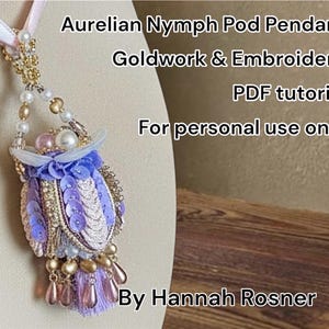May include: Aurelian Nymph Pod Pendant, a goldwork and embroidery piece with a PDF tutorial. The pendant features a lavender and gold design with sequins, beads, and a tassel. The text on the image says "For personal use only" and "By Hannah Rosner."