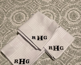 May include: Three white handkerchiefs with black embroidered initials "RHG" on each.