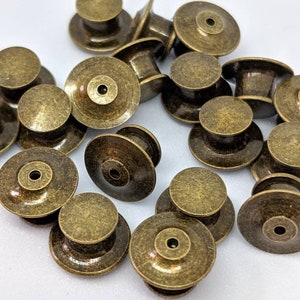12 Pack of Locking Pin Backs / Pin Keepers Never lose a Special Pin again New Styles Free domestic shipping with 35 dollar purchase. Antique Brass