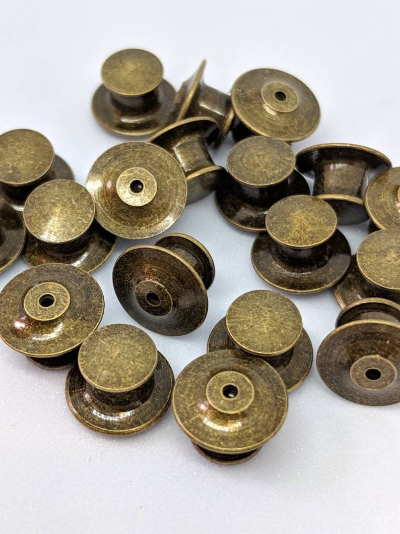 12 Pack of Locking Pin Backs / Pin Keepers Never lose a Special Pin again New Styles Free domestic shipping with 35 dollar purchase. Antique Brass