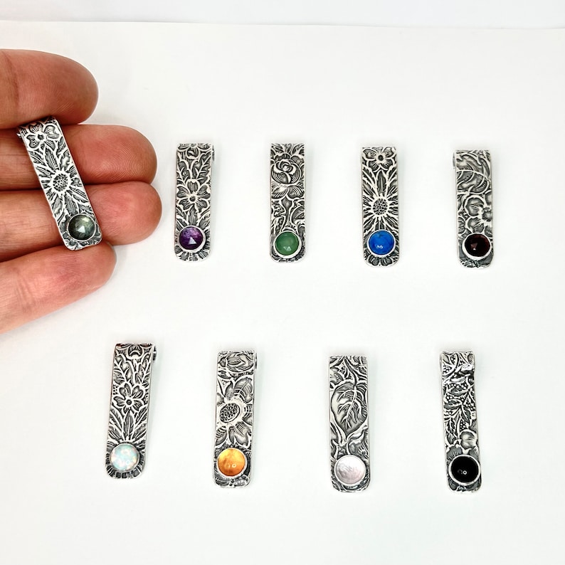 vintage flower and leaf pattern rectangle pendant with 6mm assorted gemstones including amethyst, chrysoprase, lapis, labradorite, simulated opal, garnet and black onyx. 1.25 inches long, a little over 1/4 inch wide handmade silver jewelry by hanni