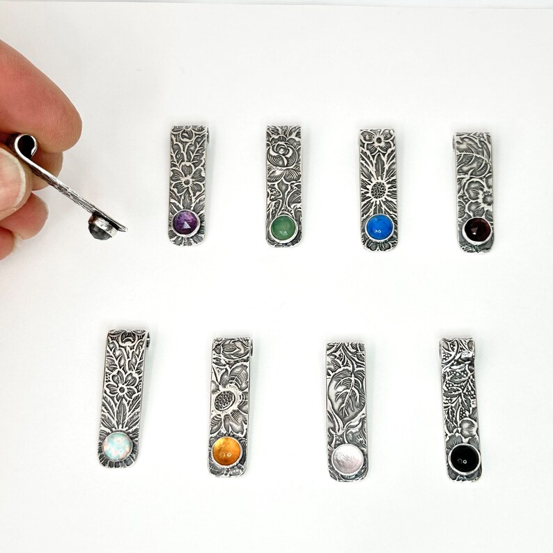 vintage flower and leaf pattern rectangle pendant with 6mm assorted gemstones including amethyst, chrysoprase, lapis, labradorite, simulated opal, garnet and black onyx. 1.25 inches long, a little over 1/4 inch wide handmade silver jewelry by hanni