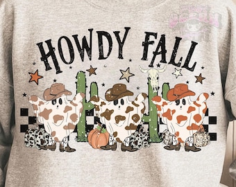 May include: A light gray sweatshirt with the words "HOWDY FALL" in black. The graphic features cartoon ghosts wearing cowboy hats and cowhide patterns, with cacti, stars, and a pumpkin.