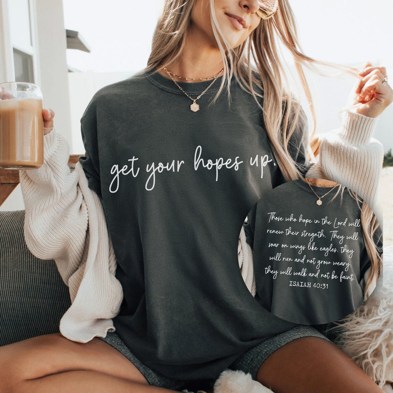 May include: A dark gray sweatshirt with the text "get your hopes up." printed in white. The sweatshirt also features a quote from Isaiah 40:31 in white text.