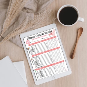 May include: A tablet displaying a skincare tracker with a pink and white design, labelled "Ultimate Skincare Tracker 2025." The tracker includes sections for morning and evening routines, product tracking, and weekly check-ins. A cup of coffee and a wooden spoon are also visible.