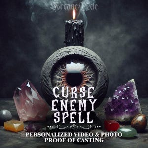 May include: An eye-shaped sculpture with the text "CURSE ENEMY SPELL" is the focal point of this image. A black candle burns above the sculpture, with smoke rising. Various crystals and gemstones surround the sculpture, including amethyst and rose quartz.