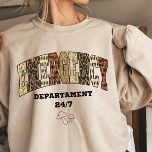 Emergency Nurse Fall Sweatshirt, ER Nurse Crewneck, Emergency Department 24/7 Graphic, Autumn Nursing Gif