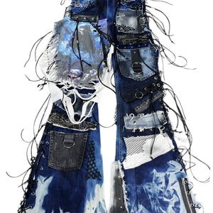 May include: Distressed denim jeans with multiple patches, lace-up details, and a skull graphic. The jeans feature a mix of textures, including mesh and leather accents, and are embellished with black cords and zippers.