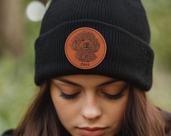 May include: Black beanie with a brown leather patch featuring a dog's face and the name "Coco" in white text.