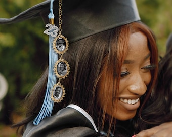 May include: A blue and silver graduation tassel with a gold chain and four round photo charms. The photos are of different people.