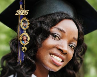 May include: A woman wearing a black graduation cap with a gold tassel and a graduation charm with the year 2025 and two photo frames. The charm is hanging from the tassel.