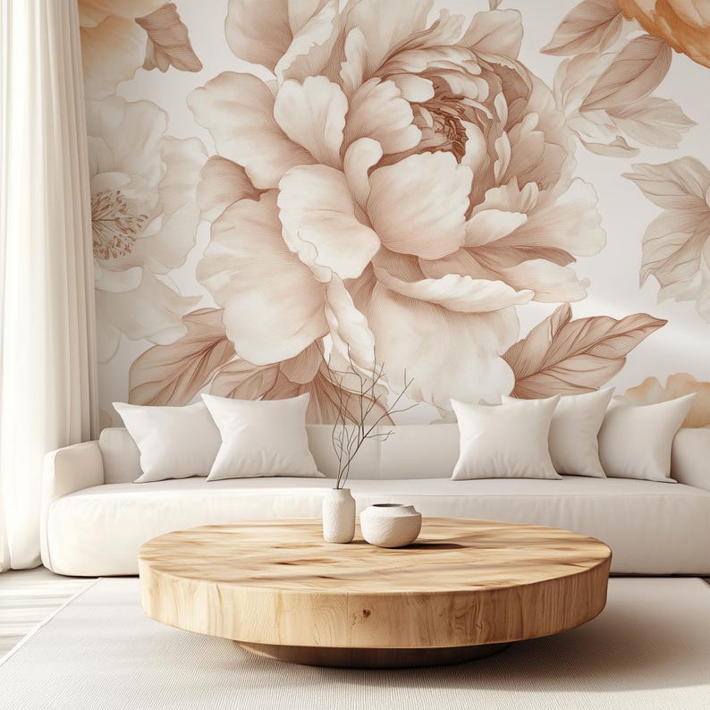 May include: A white sofa with cushions sits in front of a wall with a large floral mural. The mural features large, light brown peonies with delicate brown leaves. A wooden coffee table sits in front of the sofa.