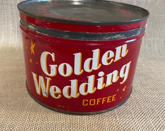 May include: A vintage red Golden Wedding Coffee tin with a black lid. The tin features white lettering with a yellow outline, and the words "Golden Wedding Coffee" are prominently displayed. Small yellow stars are scattered around the text.
