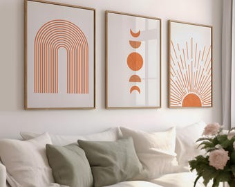 May include: Three framed prints with abstract geometric designs in shades of orange and white. The prints feature a rainbow arch, a series of crescent moons and a sun with rays.
