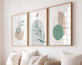 May include: Three framed prints with abstract shapes and green leaves. The prints are in a minimalist style with a white background and light brown, green, and black accents.