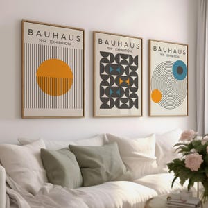 May include: Three framed prints with the text "Bauhaus 1919 Exhibition" and geometric designs in black, white, yellow, blue, and orange.