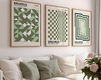 May include: Three framed prints with geometric designs in shades of green and white. The prints feature the text "BAUHAUS" and the years "1923", "1920", and "1920".