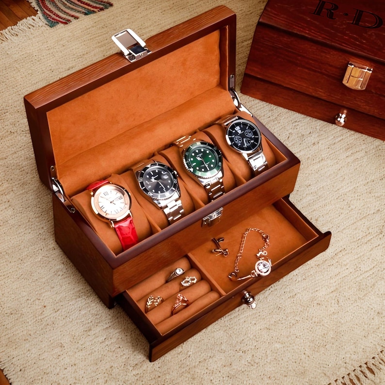 May include: A wooden watch box with a drawer. The box has a brown finish and is lined with a brown velvet-like material. The box has five slots for watches and a drawer for storing jewelry. The drawer has a small lock and key.