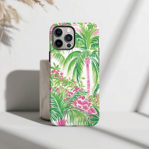 May include: White phone case with a tropical print featuring green palm trees and pink flowers.