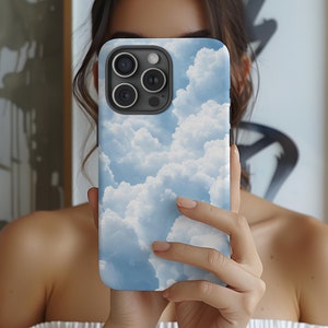 May include: A phone case with a blue and white cloudy sky design. The case has a black camera lens cutout.
