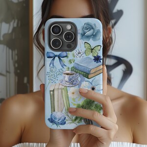 May include: A blue iPhone case with a watercolor design featuring books, flowers, a butterfly, and a teacup. The design is in shades of blue, green, and white.
