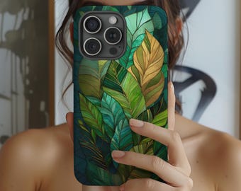 May include: A smartphone case featuring a vibrant botanical design of green and gold leaves. The case has a dark teal background and a camera module with three lenses. The design includes detailed leaf patterns with gold accents.