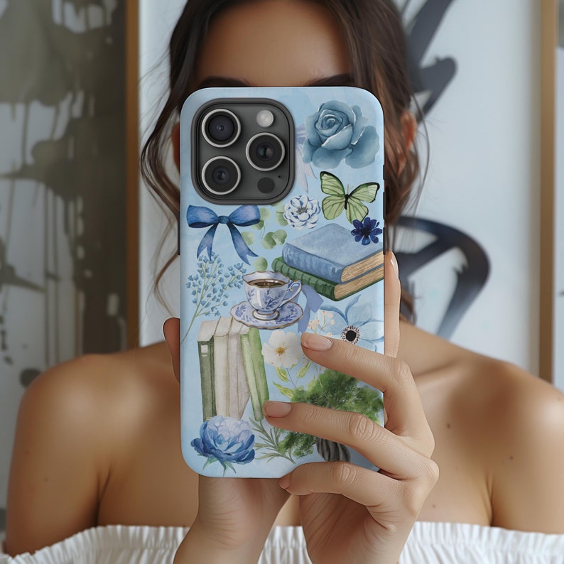 May include: A blue iPhone case with a watercolor design featuring books, flowers, a butterfly, and a teacup. The design is in shades of blue, green, and white.