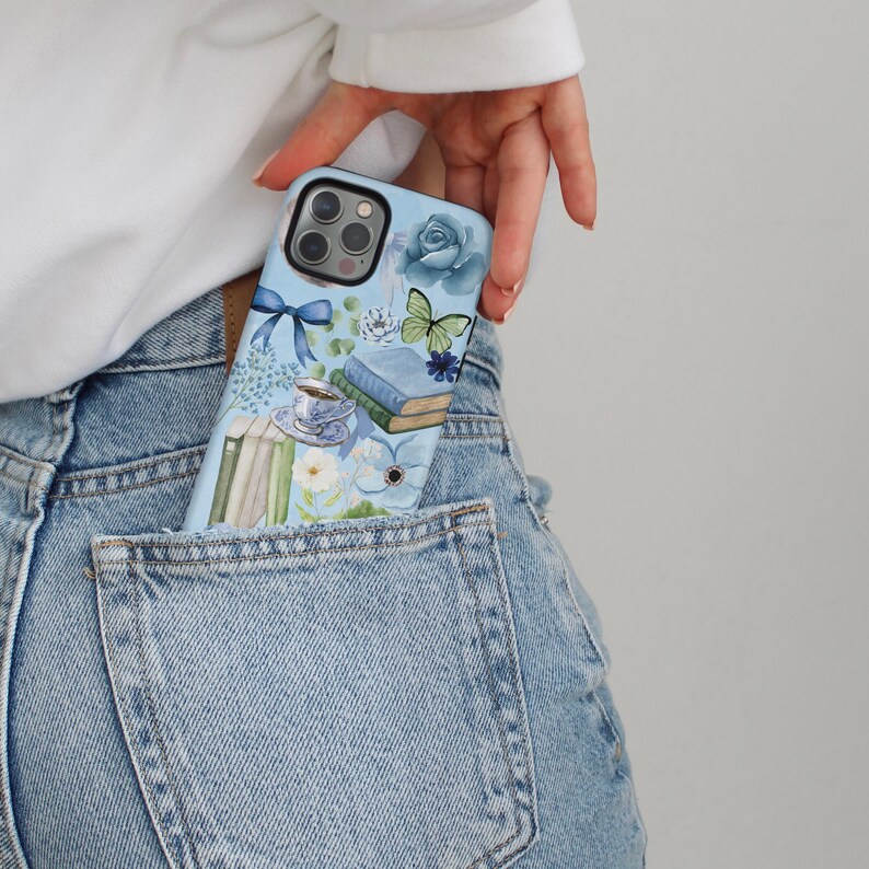 May include: A blue phone case with a floral and book design. The case features a butterfly, a rose, and a cup of tea.