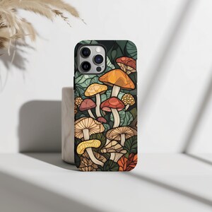 May include: A phone case with a colorful illustration of mushrooms on a dark green background.