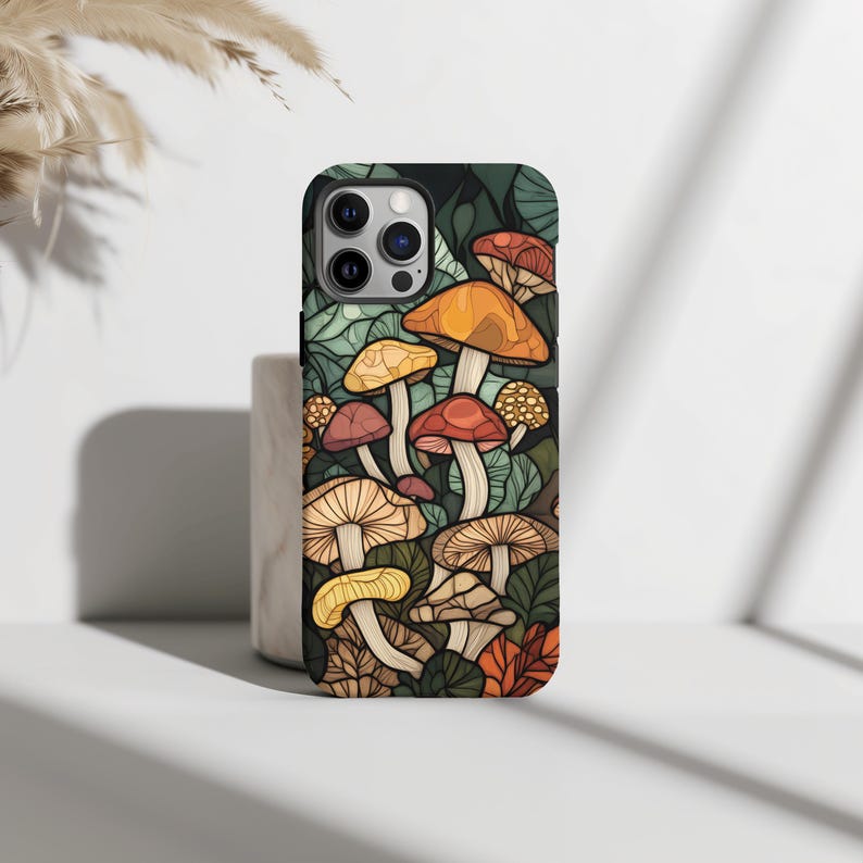 May include: A phone case with a colorful illustration of mushrooms on a dark green background.