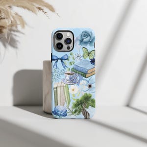May include: A blue phone case with a watercolor design featuring books, flowers, a teacup, and a butterfly.