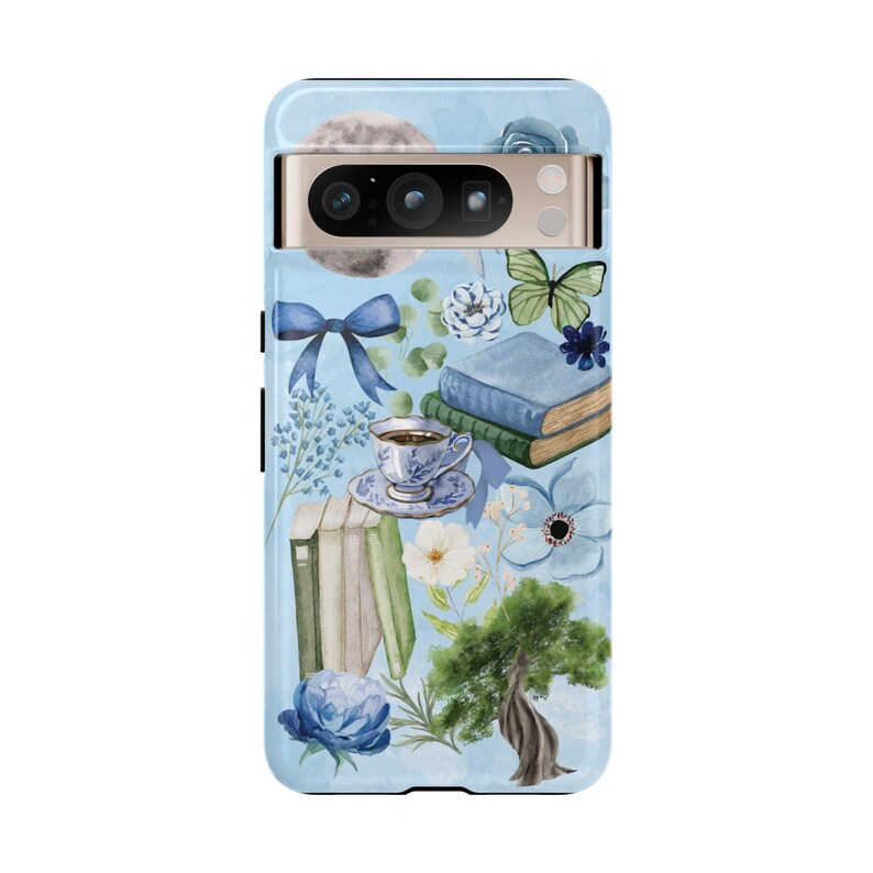 May include: A blue phone case with a watercolor design featuring books, flowers, a butterfly, a cup of tea, and a moon. The case has a cutout for the camera lens.