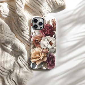 May include: A white phone case featuring a floral design with peonies in shades of burgundy, peach, cream, and yellow. The case has a glossy finish and a camera cutout. The design is a watercolor style.