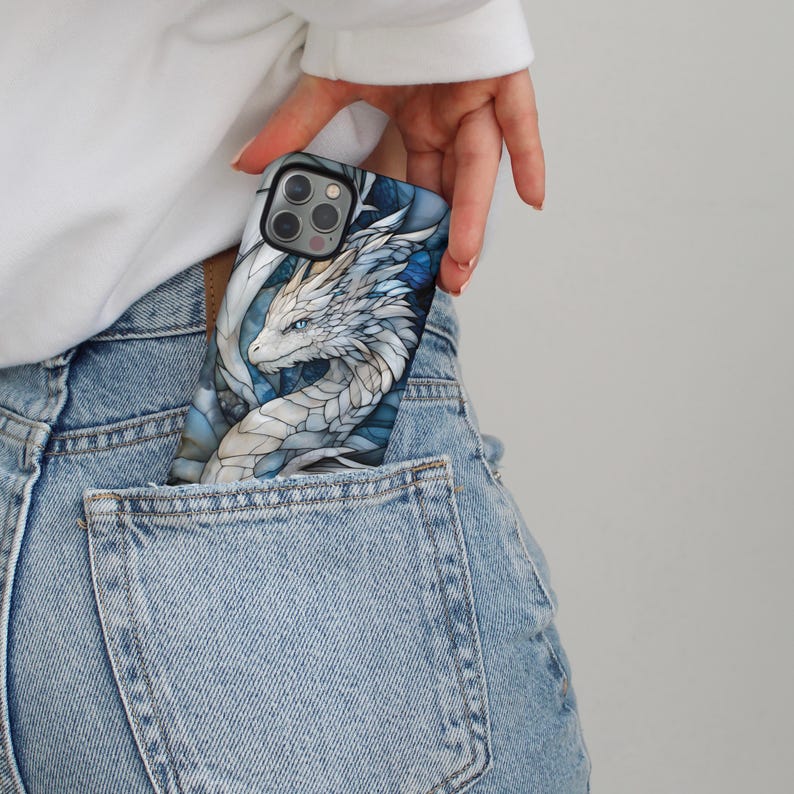 May include: A blue and white phone case featuring a dragon design. The dragon is white with blue accents and has a detailed design.