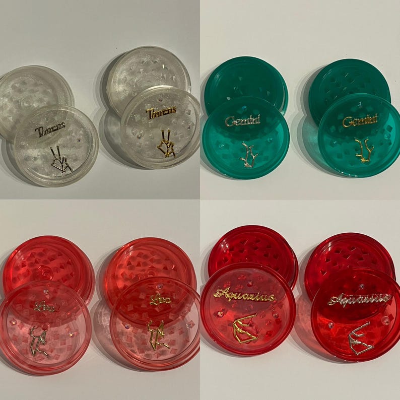 May include: Set of six clear plastic grinder lids with zodiac signs. The lids are in three colors: white, green, and red. The zodiac signs are Taurus, Gemini, and Aquarius.