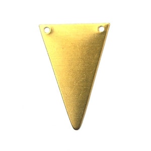 May include: A gold triangle-shaped metal pendant with two holes at the top for attaching a chain or cord.