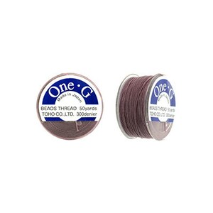 May include: A spool of brown thread labeled "One.G Beads Thread 50yards TOHO CO.,LTD. 300denier" and "Made in Japan".