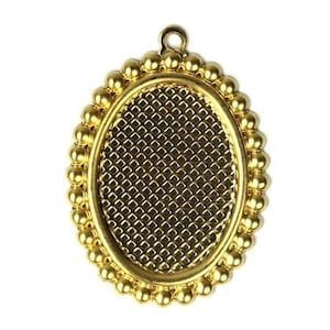 May include: Gold oval pendant with a beaded border and a textured surface. The pendant is designed for use with resin or other crafting materials.
