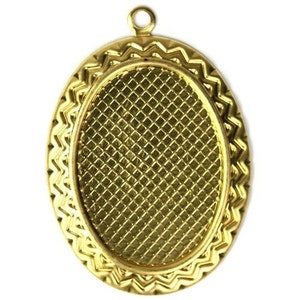 May include: Gold oval pendant with a decorative, textured, patterned border. The pendant has a smooth, flat, oval-shaped center.