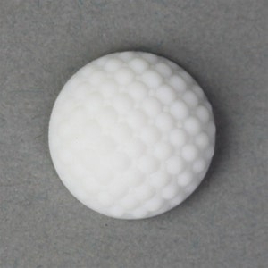 May include: White ceramic button with a textured surface resembling a golf ball.