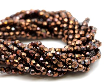 Filo di perline in vetro a tonda leggermente sfaccettata trasparente grigio con bordo oro anticato, circa