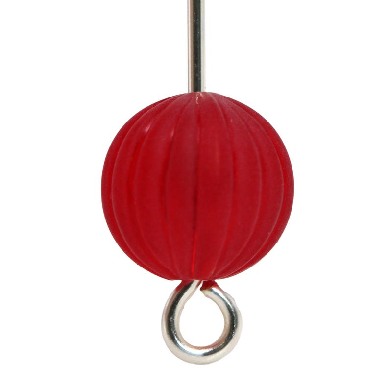 May include: A close-up of a red, ribbed sphere with a silver metal loop and a silver metal rod. The sphere is a vibrant red color and has a textured surface. The object is isolated against a white background.